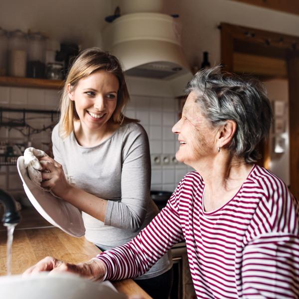 helping senior citizen in kitchen