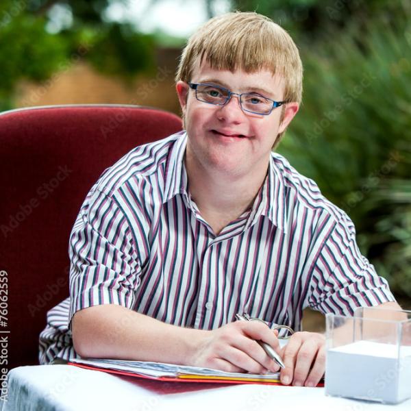 young man holding work book